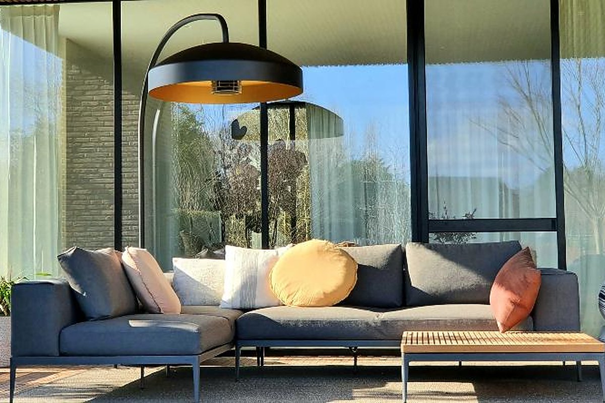 Lampa grzewcza Heatsail Disc FS nad narożnikiem wypoczynkowym na tarasie przy przeszklonym domu